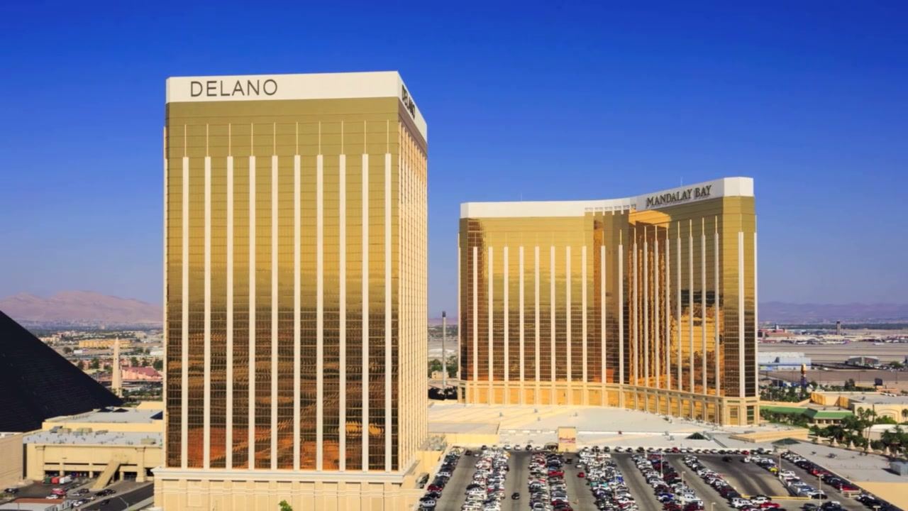 Aerial photo of gold-glass resort towers on the south Las Vegas Strip at golden hour