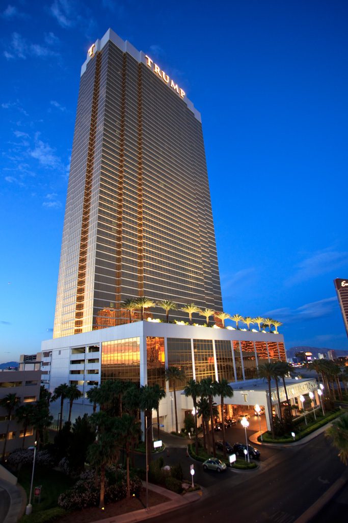 Gold glass hotel tower against a deep blue twilight sky
