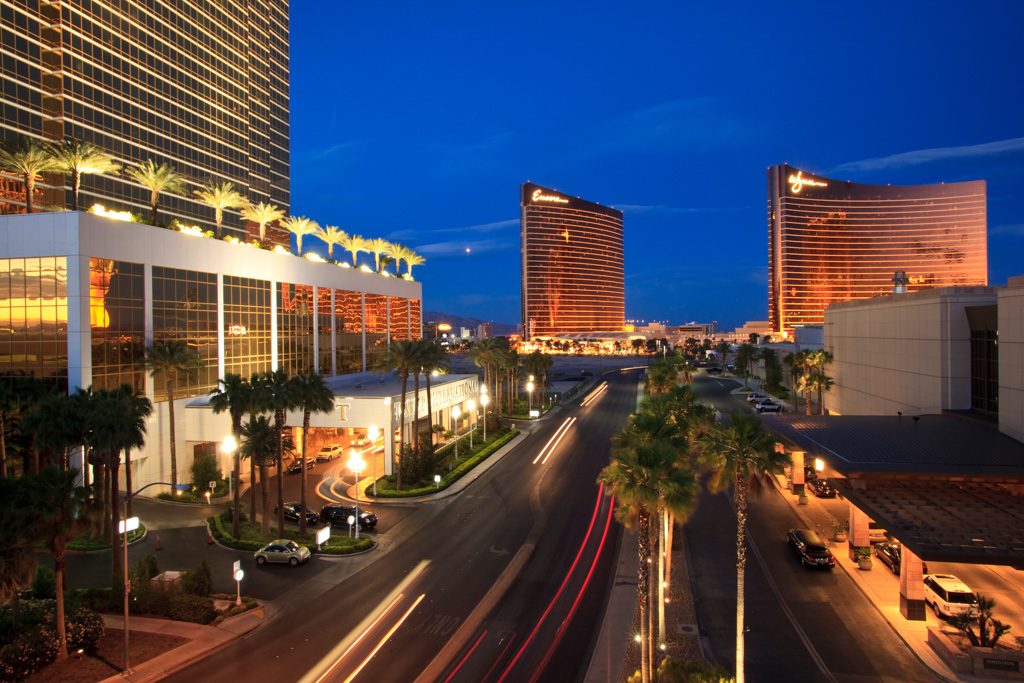 Las Vegas Strip resort towers and traffic light trails at dusk